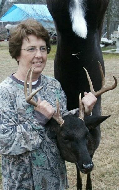 woman with melanistic/ black whitetail deer